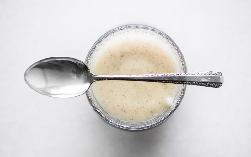 A glass of Kentucky Bourbon Vanilla Bean Pudding with spoon