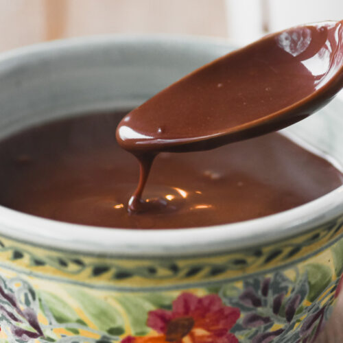 Spooning thick Castilian hot chocolate out of a mug.