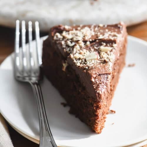 a slice of dark chocolate hazelnut cake with fork.