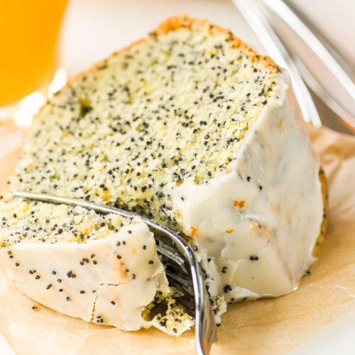 A slice of tangerine poppy seed cake with fork.