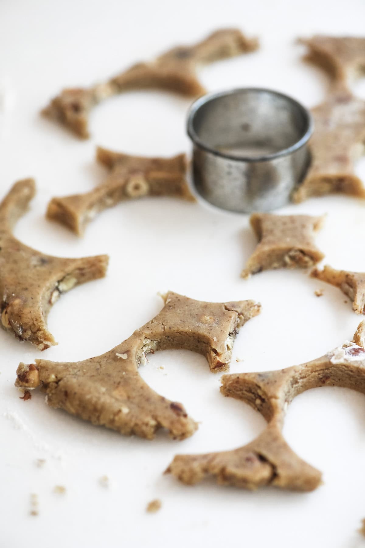 cutting out coffee hazelnut shortbread cookies from dough.