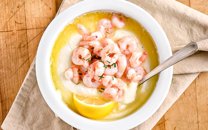 Edna Lewis' simple shrimp and grits in a white bowl.