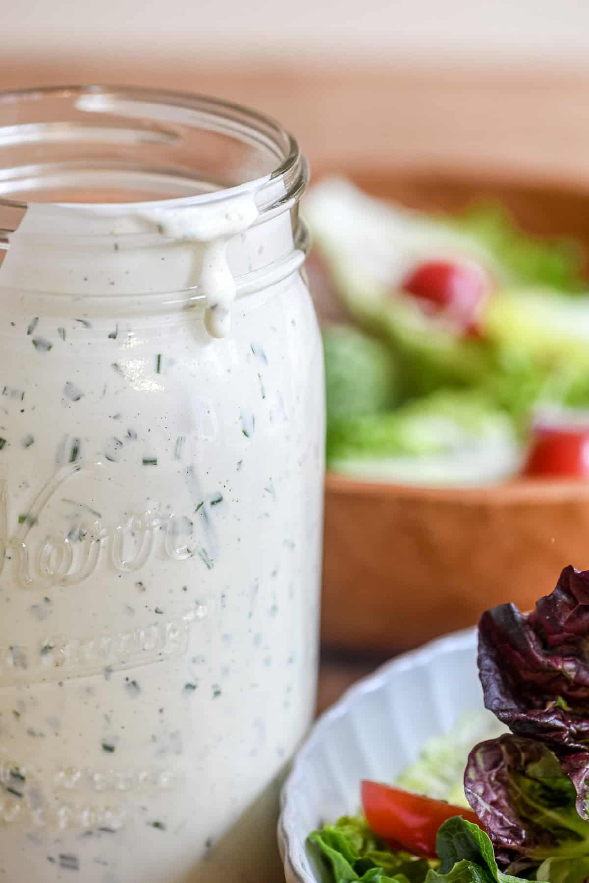 Close look at buttermilk dressing in a mason jar.