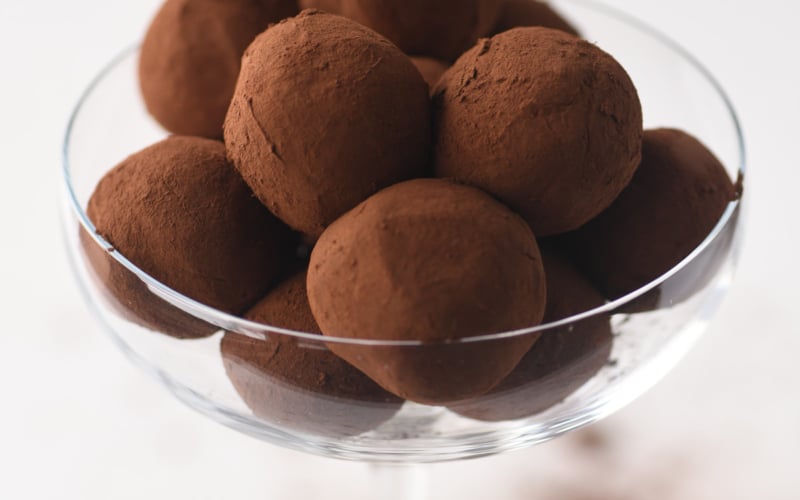 Easy homemade chocolate truffles in a glass bowl.