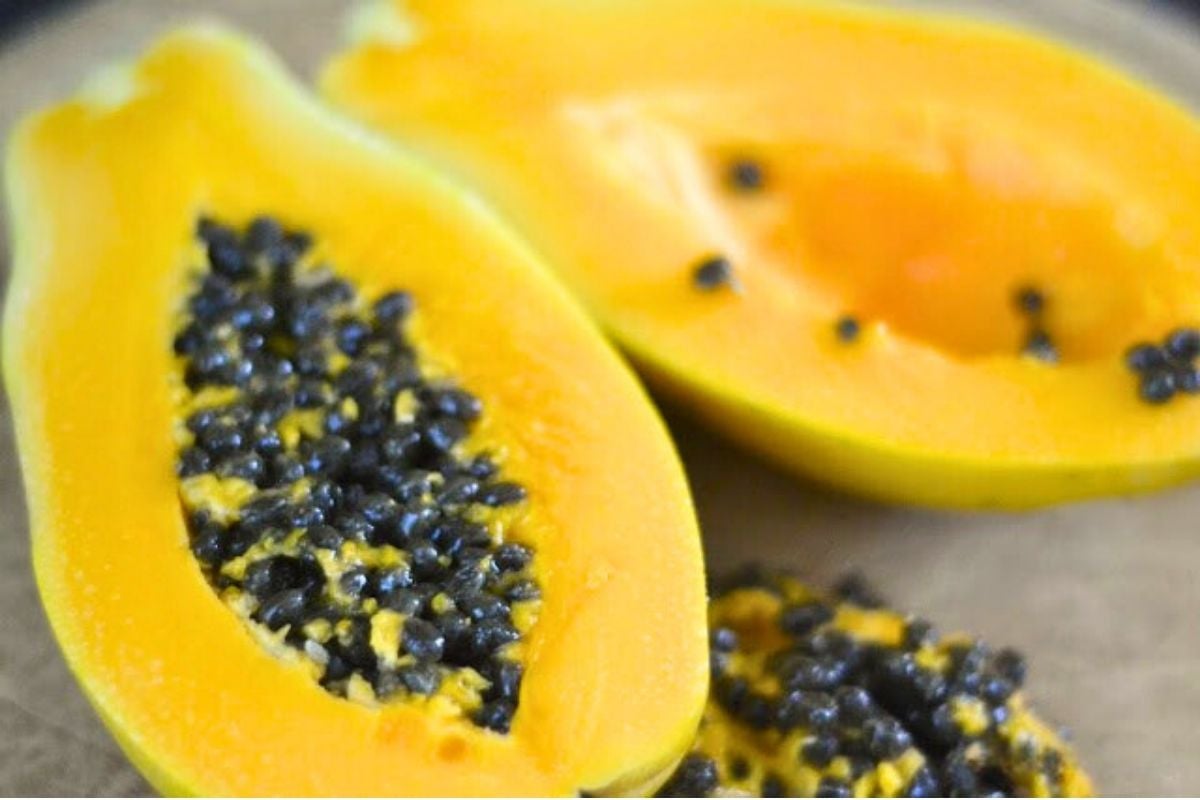 sliced papaya with black seeds.