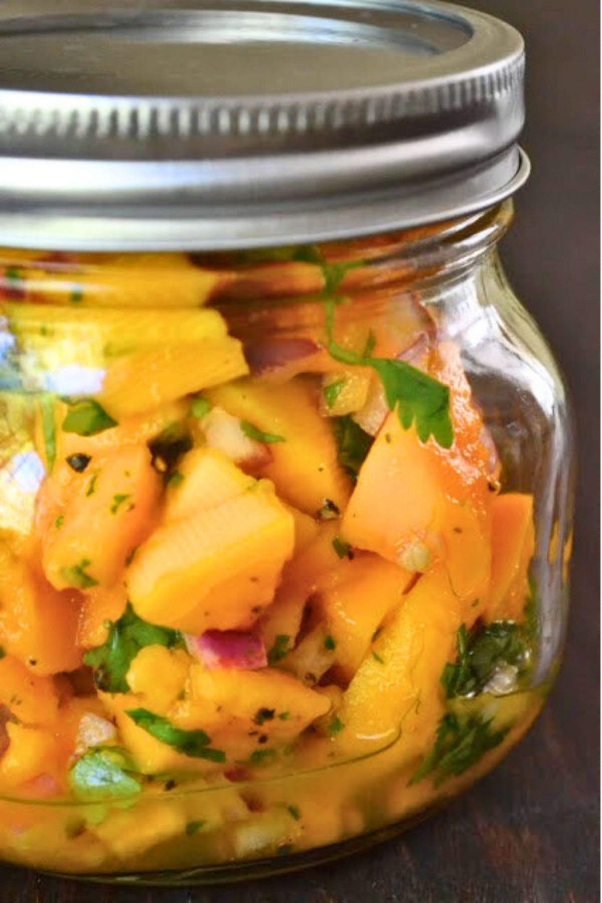 a small mason jar filled with homemade papaya salsa.