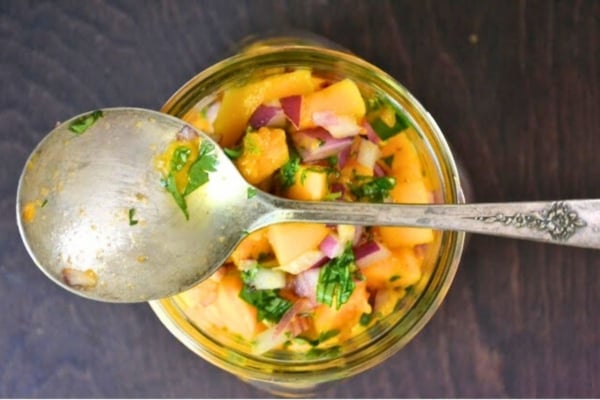 a small jar of homemade papaya salsa, with spoon.