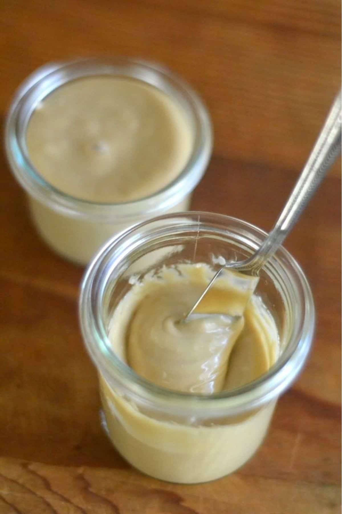 Maple cream in small glass jars, with knife.