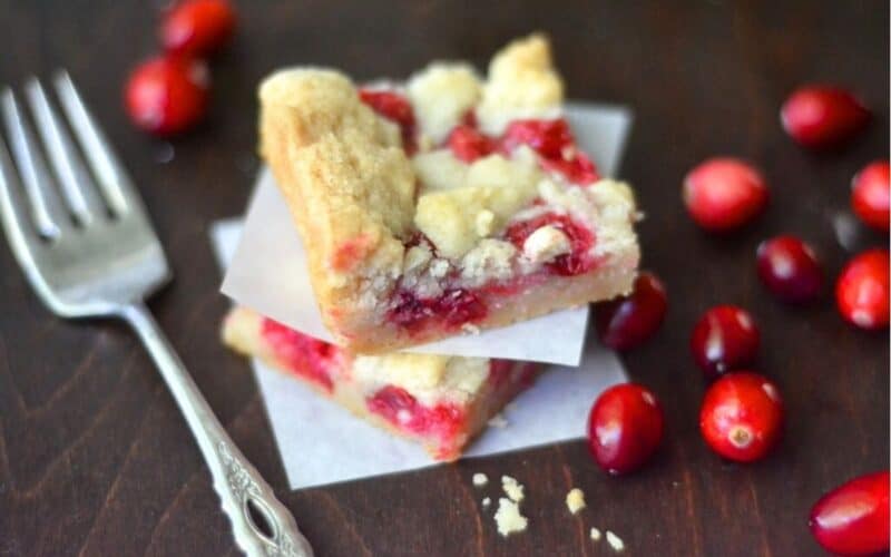 Fresh cranberry bars, stacked, with fork.
