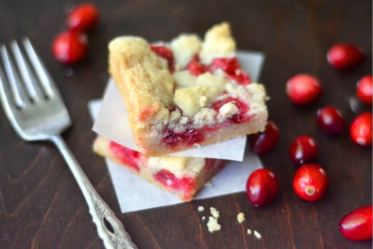 Fresh cranberry bars, stacked, with fork.