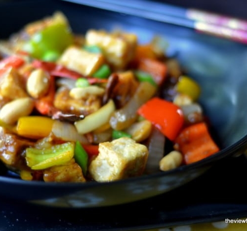 Kung Pao Tofu in a black bowl