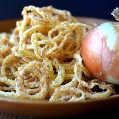Vidalia onion strings in a wooden bowl.