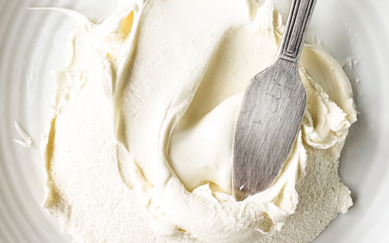 Homemade mascarpone cheese, with spreading knife.