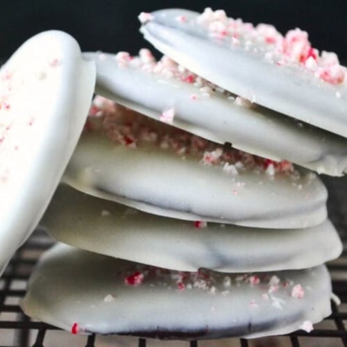 A stack of no bake white chocolate thin mints, on a rack.