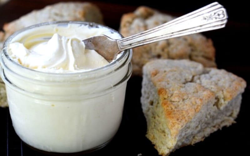 clotted cream in a small jar, with scones.