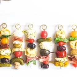 A lineup of antipasto skewers on an appetizer platter.