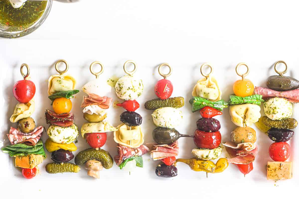 A lineup of antipasto skewers on an appetizer platter.