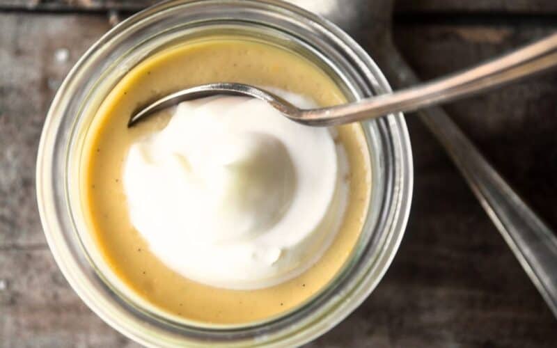 small jar of salted maple pot de creme with spoon.