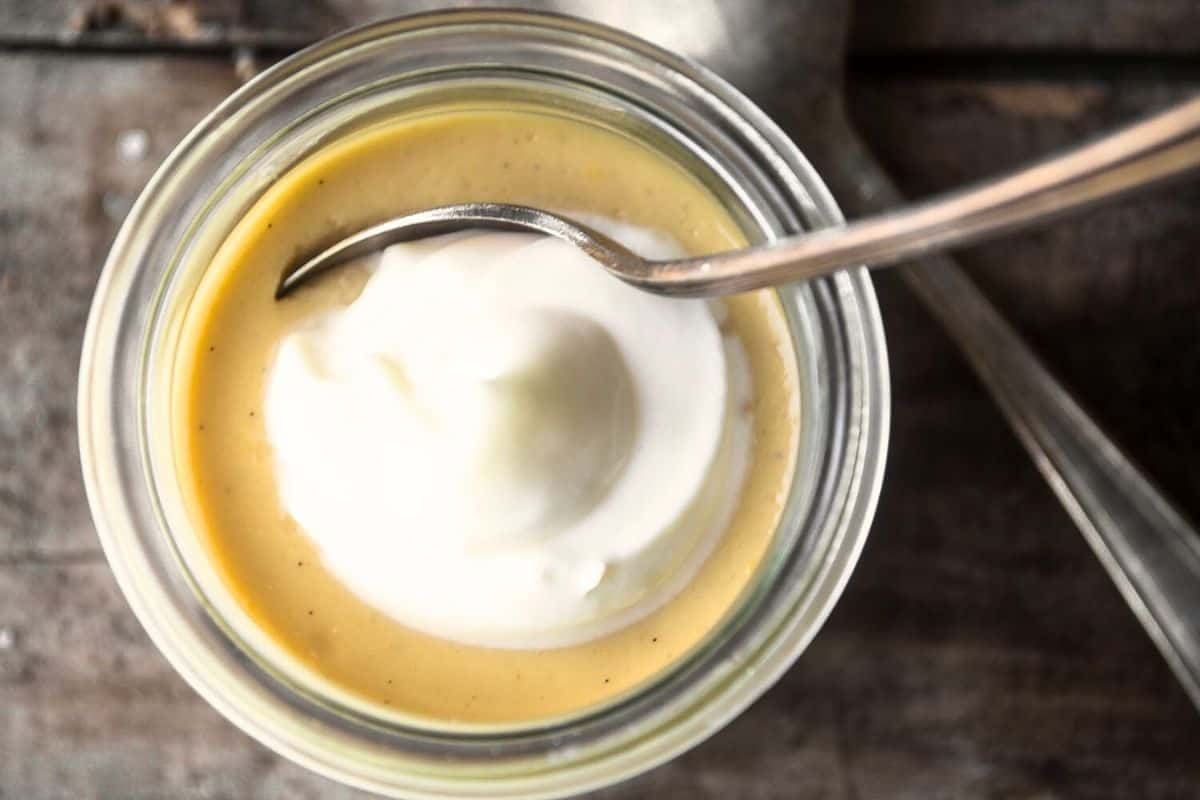 small jar of salted maple pot de creme with spoon.