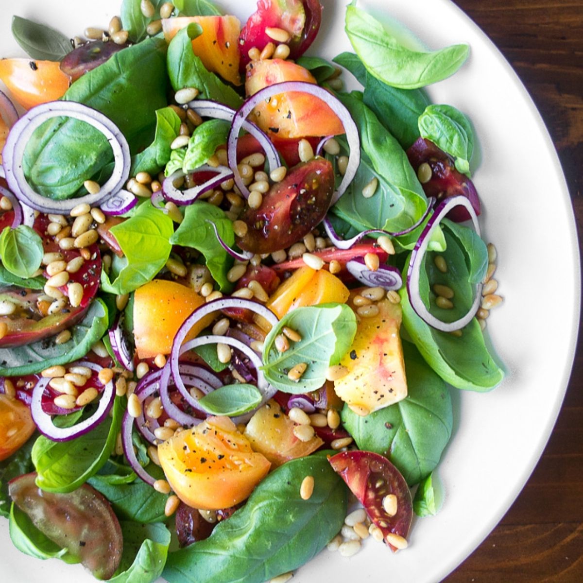 colorful basil leaf salad with heirloom tomatoes.