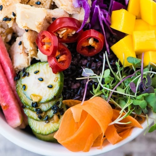A tuna poke bowl with vegetables.