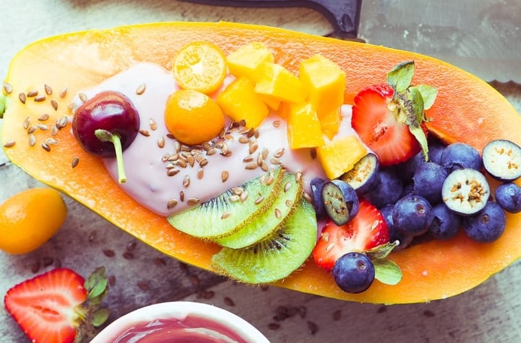 Papaya breakfast boat with yogurt and fruit