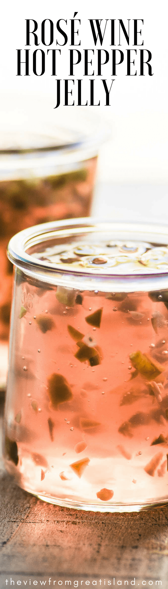 Rosé Wine Hot Pepper Jelly ~ a simple sweet/hot wine jelly that turns cheese and crackers into a gourmet experience. This pretty homemade hot pepper jelly makes a unique host gift! #hotpepperjelly #rosewine #wine #winejelly #holidayappetizer #cheeseplate #cheeseandcrackers #cheese #appetizer #pepperjelly #jalapenos #small batch #freezerjam #holidayfoodgift #hostessgift #cocktails #cocktailparty