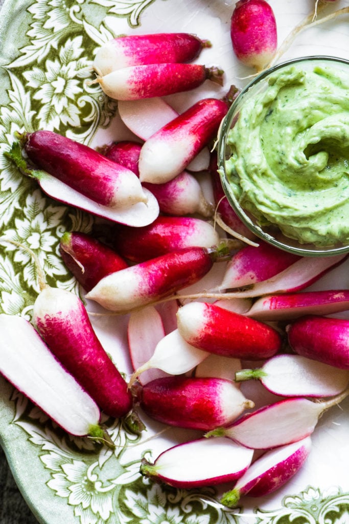 French breakfast radishes with herb butter on a platter