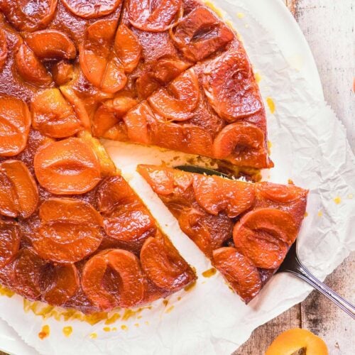 slicing an caramelized apricot upside down cake.