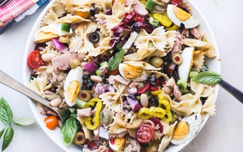 Mediterranean Pasta Salad with Tuna in a white bowl