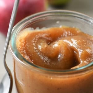 apple butter in a small glass jar.
