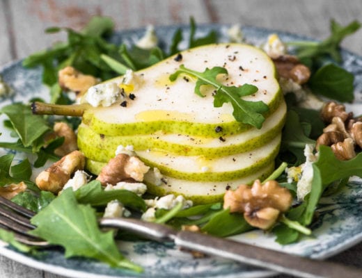 A plate of pear salad with creamy walnut vinaigrette