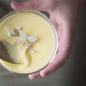 holding a glass of grapefruit blossom pot de creme.