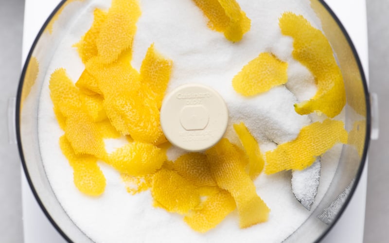 Making citrus sugar in a food processor with sugar and lemon zest