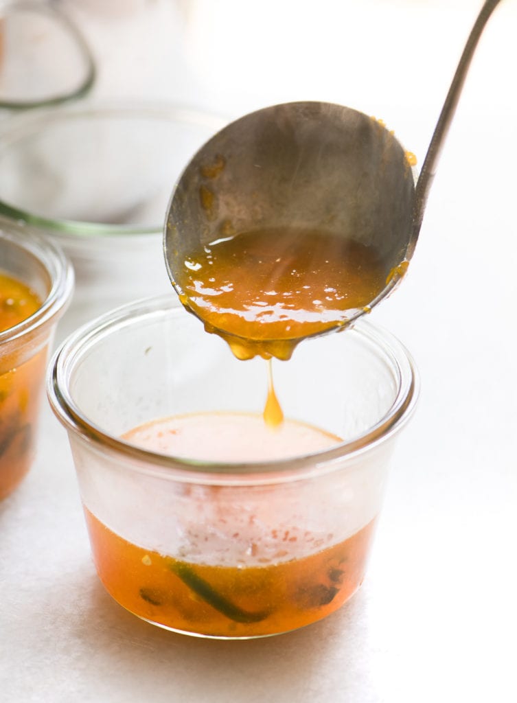 ladling hot apricot jalapeño jam into jars