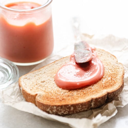 homemade rhubarb curd being spread on toast