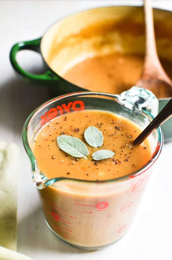 cider sage gravy in measuring cup