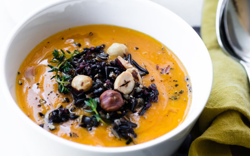 a small bowl of wild rice and carrot soup
