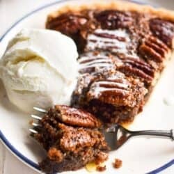 pecan frangipane pie with scoop of ice cream.