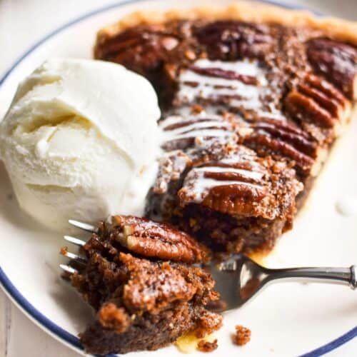 pecan frangipane pie with scoop of ice cream.
