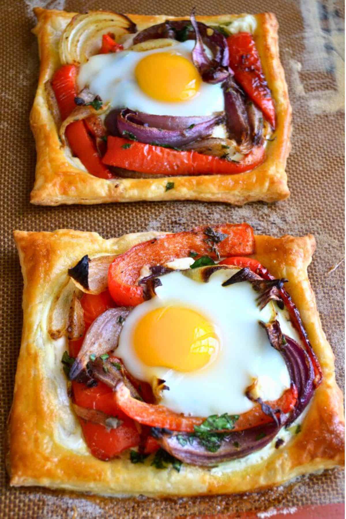 Red Pepper and Baked Egg Galettes from Jerusalem (the book) ~ these eggs baked in puff pastry are the ultimate breakfast in bed recipe! #eggs #breakfast #brunch #puffpastry #bakedeggs #breakfastinbed #mothersday #valentinesday #Christmasbreakfast #holidaybreakfast #ottolenghi #jerusalem Colorful puff pastry egg galettes with red peppers.