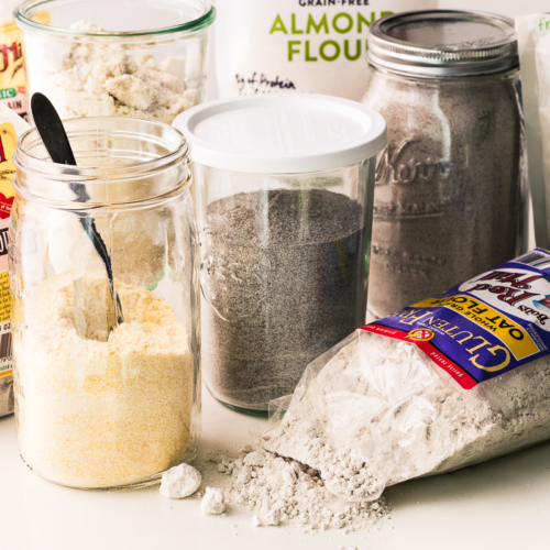 variety of flours in jars and bags