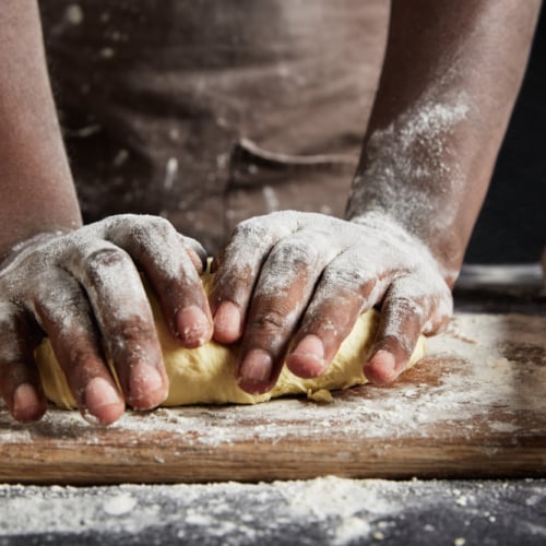 black chef kneading dough