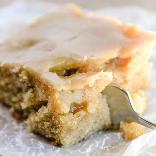 taking a bite of a piece of caramel glazed apple cake