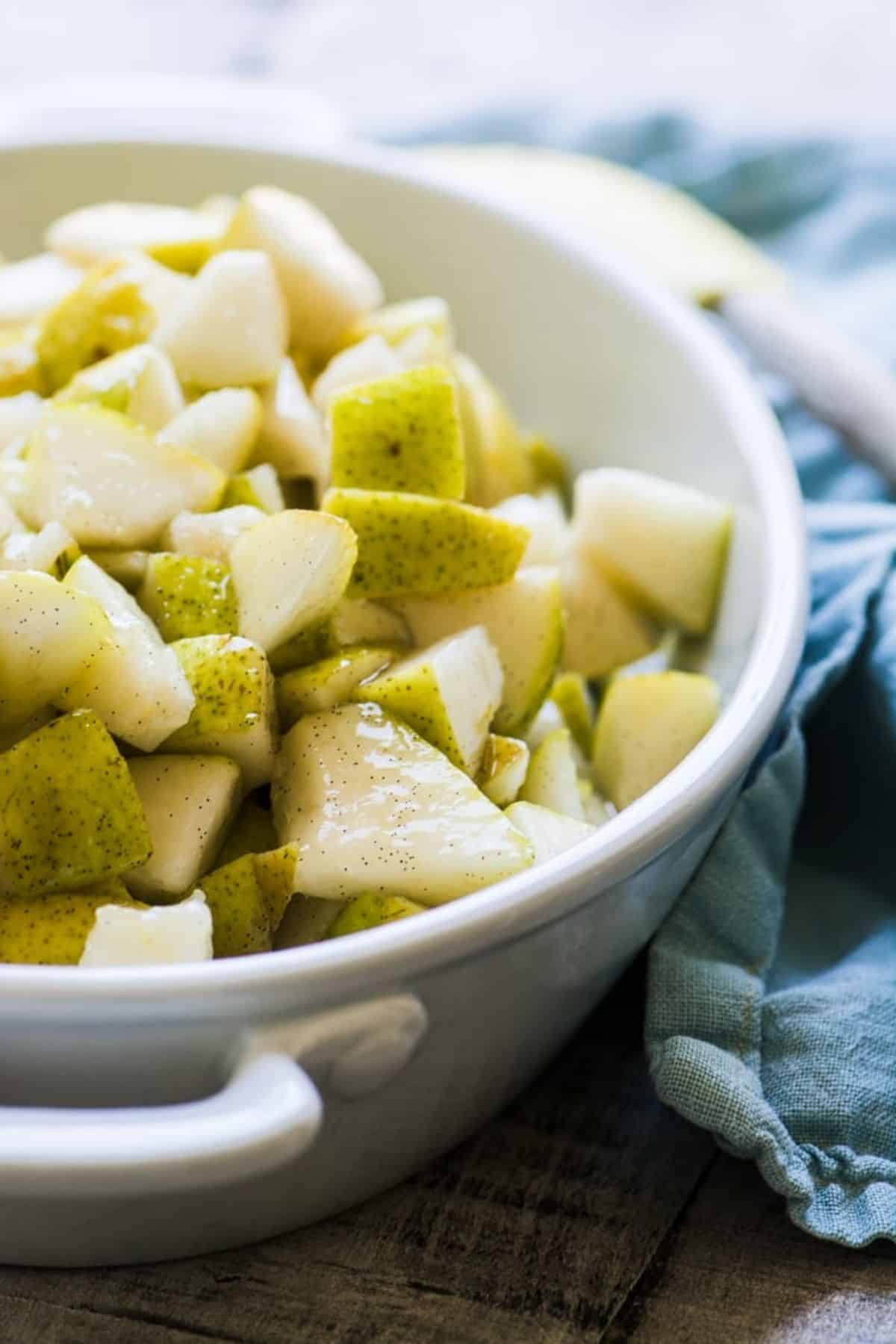 Pears in a baking dish for pear crisp.
