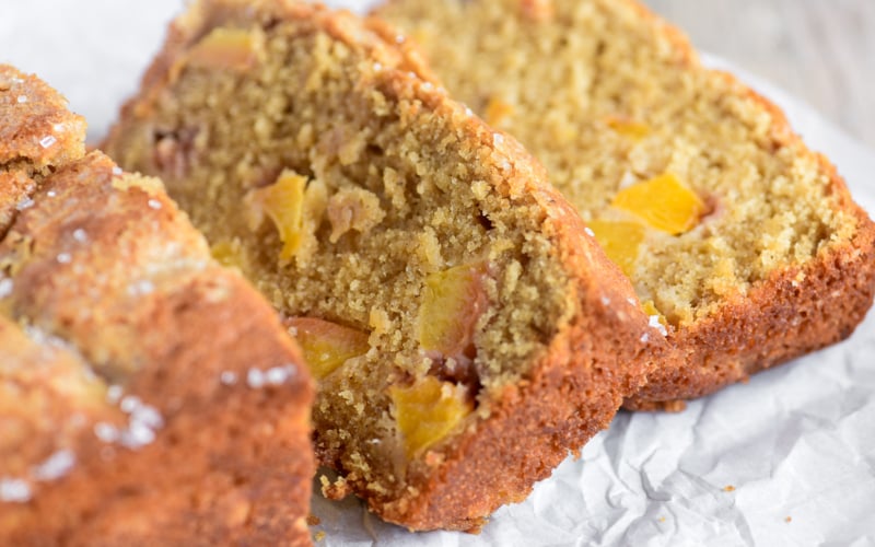 spiced peach bread, sliced on parchment paper