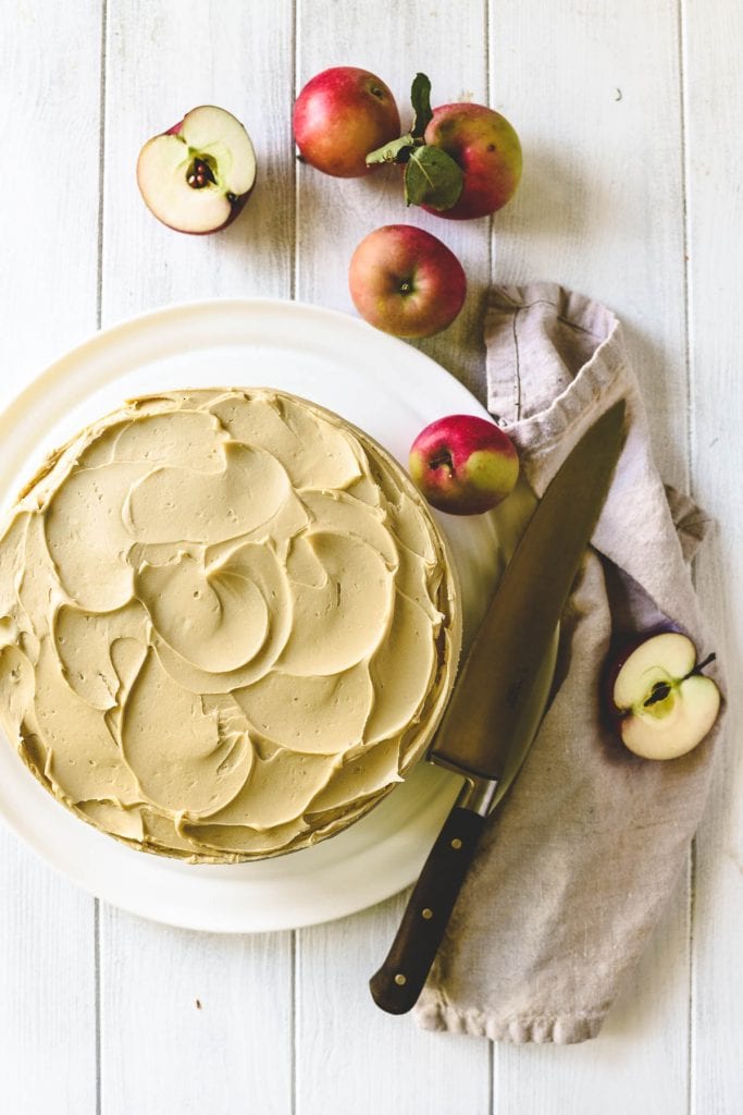 apple butter cake on a platter with apples