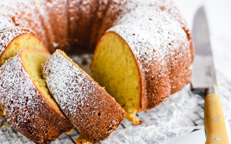 freshly baked buttermilk pound cake on a rack with knife