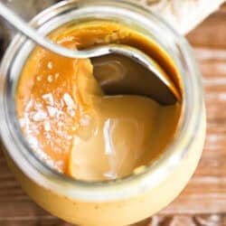 Salted caramel pot de creme in a small jar with spoon.
