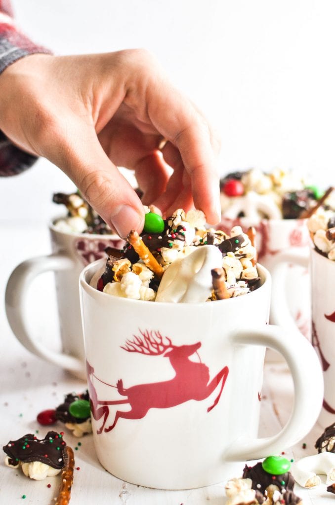 A person holding holiday popcorn